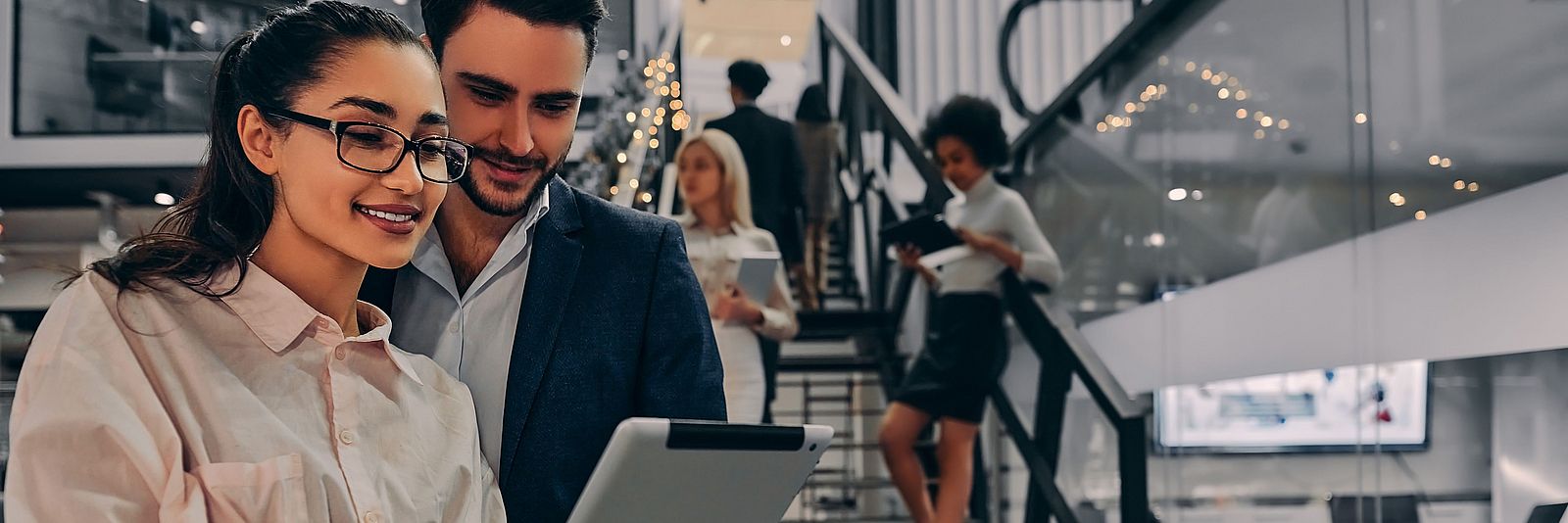 Man and woman in the office looking at the tablet
